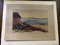 Photo of the watercolor painting showing the coastal scene with a lobster shack and boats, unframed on table