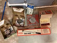 Photo showing roto strippers and bits in boxes, Craftsman torque wrench box, and molding kit with bits and blades in packaging.