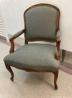 Full front view showing carved wooden frame and seat shape