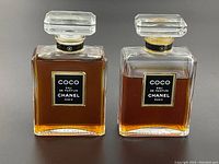 Front view of two rectangular glass perfume bottles side by side showing black and gold Coco Eau de Parfum Chanel labels