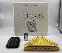 All four items arranged together: book, travel case, lighter and ashtray