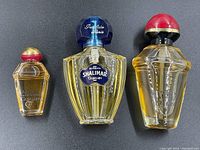 Three Guerlain perfume bottles - small Samsara Eau de Parfum, medium Shalimar Eau de Toilette, medium Samsara Eau de Toilette