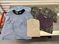 All five tops arranged on metal table