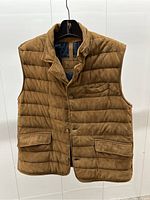 Front view of camel-brown suede quilted vest on hanger