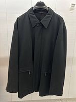 Front view of black jacket showing collar, placket, pockets
