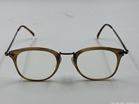 Front view of brown translucent front prescription eyeglass frames with silver toned metal bridge and arms