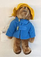 Full front view of bear in coat and hat