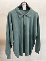 Front view of sweater hanging on hanger