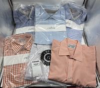Overview of six shirts: five packaged Creeds shirts and one unwrapped Turnbull & Asser shirt.