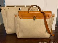 Front view of both tote bags showing size difference and overall design.