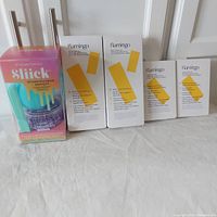 Photo of the five waxing kits including one Salon Perfect Sliick microwave kit and four Flamingo wax kits, showing packaging and quantity.