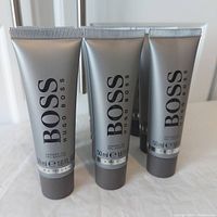 Close-up photo of the front of Hugo Boss Bottled shower gel tubes showing branding and size details.