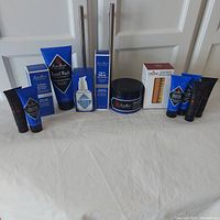 Full view of all Jack Black grooming products and Cremo Beard Brush displayed on a table.