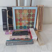 Full view of the boxed makeup items arranged on a white surface, showing all products included in the lot.