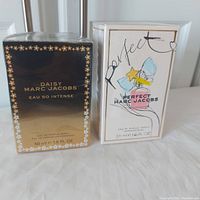 Two boxed and cellophane sealed Marc Jacobs perfume bottles, Daisy Eau So Intense and Perfect.