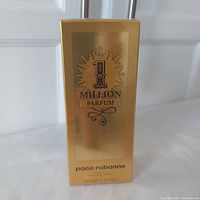 Front view of the gold packaging showing "1 Million Parfum" logo and brand name "paco rabanne" with volume size 100ml 3.4 FL OZ.