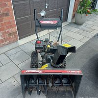Front view of Snowflite snowblower showing housing, auger and chute