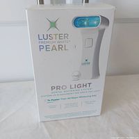 Front of the Luster Premium White Pearl Pro Light Dental Whitening System box showing main product name and image of the device.