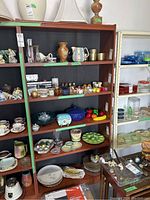 Full view of tall wooden bookcase filled with various dishes and glassware (content not included).