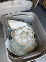 Grey tote containing wrapped dinnerware pieces