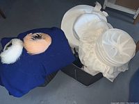 Three vintage fur hats, two vintage summer hats, and hat boxes arranged together