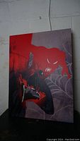 Photo of the original Spiderman painting showing the art with spider web design and red and black color scheme