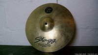 Full view of 12 inch Stagg splash cymbal showing Stagg brand and model info.