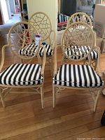 Front view of all four chairs showing frames, backs, seats and cushions.