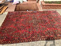 Both rugs side by side on outdoor brick surface