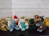 Twelve assorted Ty Attic Treasures plush Beanie Baby toys from the 1990s with original tags visible, arranged on a black surface against neutral background.