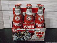 Front of the 6-pack showing bottles and commemorative graphics featuring the Boston Red Sox 2004 World Series Champions.