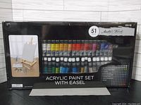 Full view of the package showing the paint tubes and easel inside, sealed box.