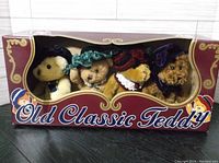 Front view of the set of four Old Classic Teddy Bears in original packaging, showing their Victorian hats and detailing.