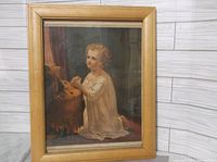 Full view of the framed G.F. Gilman chromolithograph showing a child kneeling in prayer in a light wooden frame.