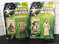 Two Star Wars Power of the Jedi action figures in original packaging showing Ben Obi-Wan Kenobi and Qui-Gon Jinn.