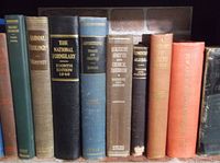 Spine view of 9 vintage hardcover books including Animal Biology, The National Formulary 1948, Introduction to Trade Practice, Chemical Analysis of Cement, Elementary Algebra, History of Architecture, and others.