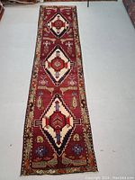 Full-length view of runner laid flat on floor showing overall pattern and length.