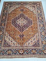Full top view of rug showing overall pattern, central medallion and border