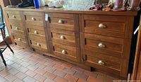 Front view showing twelve drawers and brass cup handles