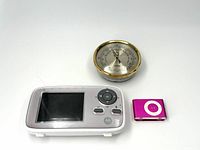 Motorola baby monitor, Stockburger barometer, and pink Apple iPod Shuffle in single image