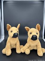 Front view of two vintage Douglas dog dolls seated side by side, showing the details of their faces, ears and front legs.