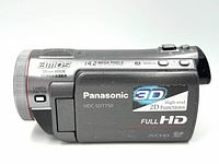Side view of Panasonic camcorder showing model number, 3D and Full HD branding, 14.2 megapixel and 3MOS sensor markings.