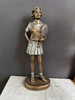 Full front view of the 15-inch bronze-tone female tennis player sculpture showing detailed outfit and pose with tennis racket.