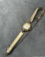 Full view of the Hamilton ladies windup watch showing gold-filled band and chain.