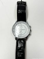 Front view of vintage Marco Max wristwatch with white dial, chronograph subdials, and black leather strap.