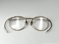 Front view of round vintage Shuron eyeglasses with gold-filled frame on white background.