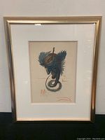 Full view of framed print leaning against a wall