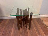 Assembled table, front view showing wood base and glass top