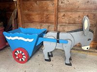 Side view of the wooden donkey with attached blue cart showing size and design.