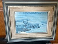 Framed blue-toned print of a polar bear and cubs on ice, showing full front view of framed artwork.